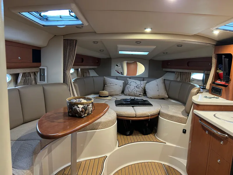 Slide: The Image of 2003 Chaparral 330 Signature Cruiser interior with cozy seating and elegant wood finishes. - 23