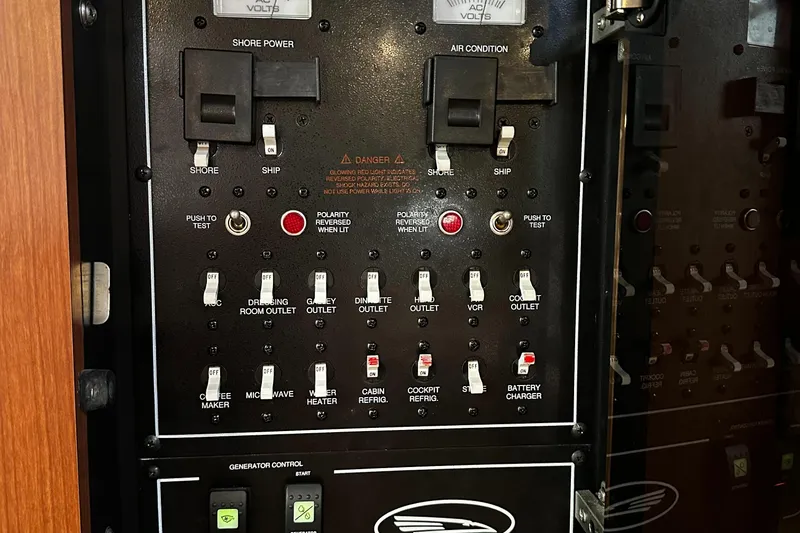 Slide: The Image of Control panel of a 2003 Chaparral 330 Signature Cruiser with various switches and indicators. - 24