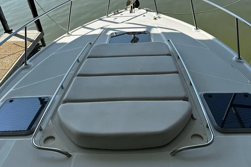 Slide: The Image of 2003 Chaparral 330 Signature Cruiser deck with cushioned seating and railing. - 27