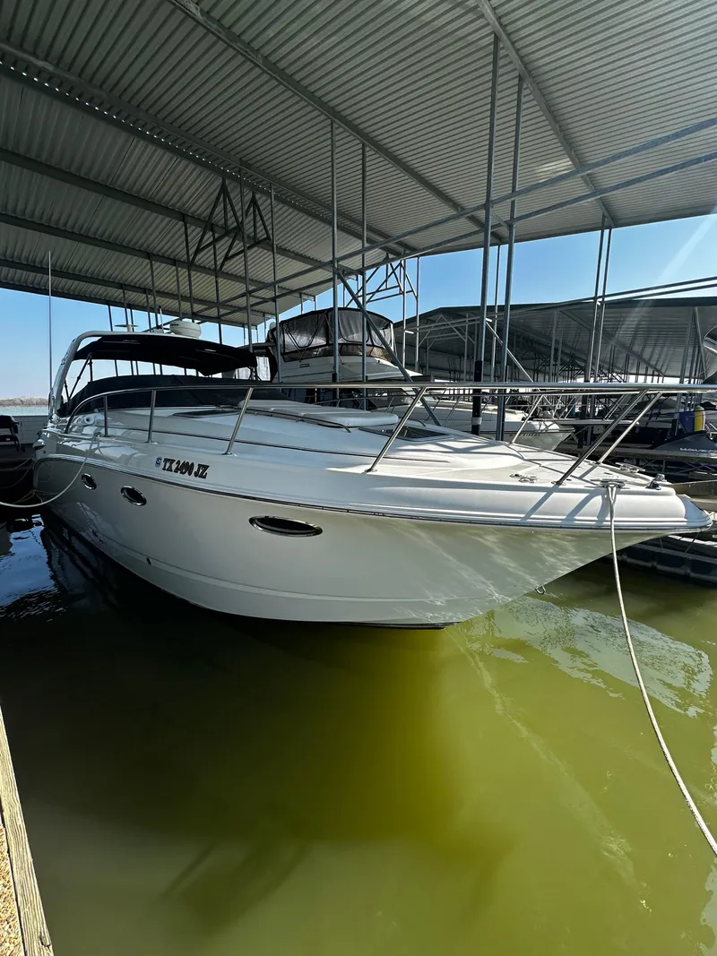 Slide: The Image of 2003 Chaparral 330 Signature Cruiser docked under a covered marina. - 4