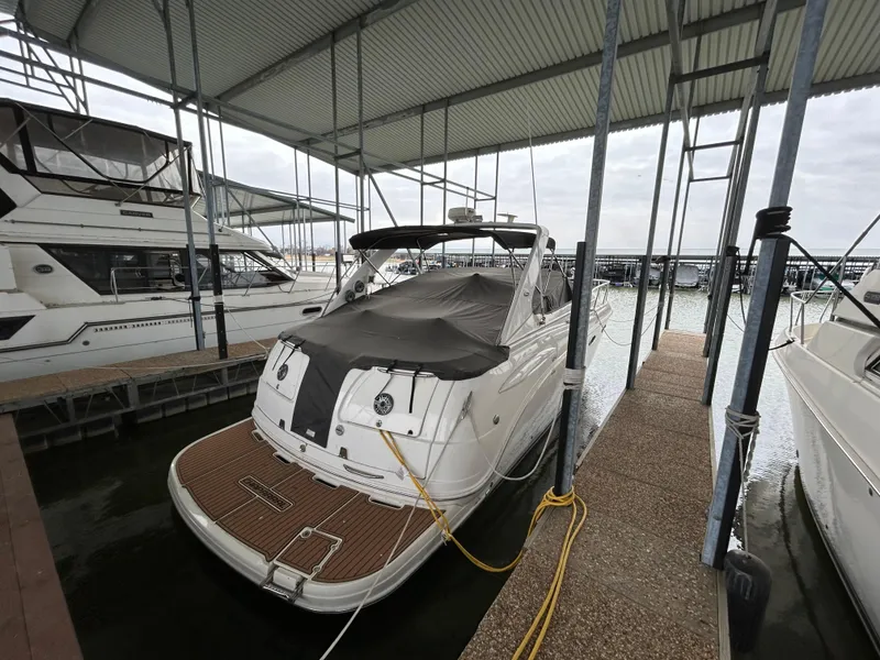 Slide: The Image of 2003 Chaparral 330 Signature Cruiser docked under a covered marina. - 6