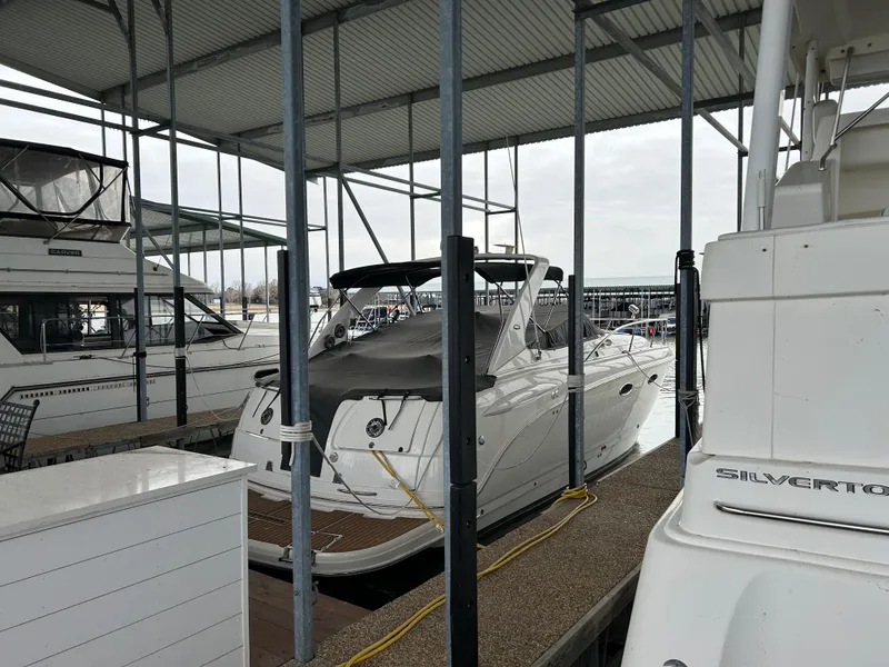 Slide: The Image of 2003 Chaparral 330 Signature Cruiser docked in a marina under a covered shelter. - 8