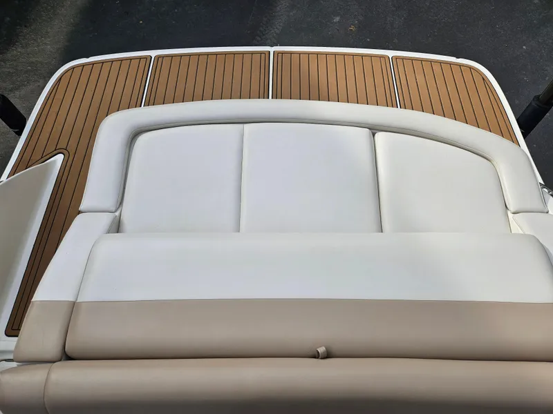 Slide: The Image of 2013 Sea Ray 230 SLX boat with white and beige seating, teak deck. - 24