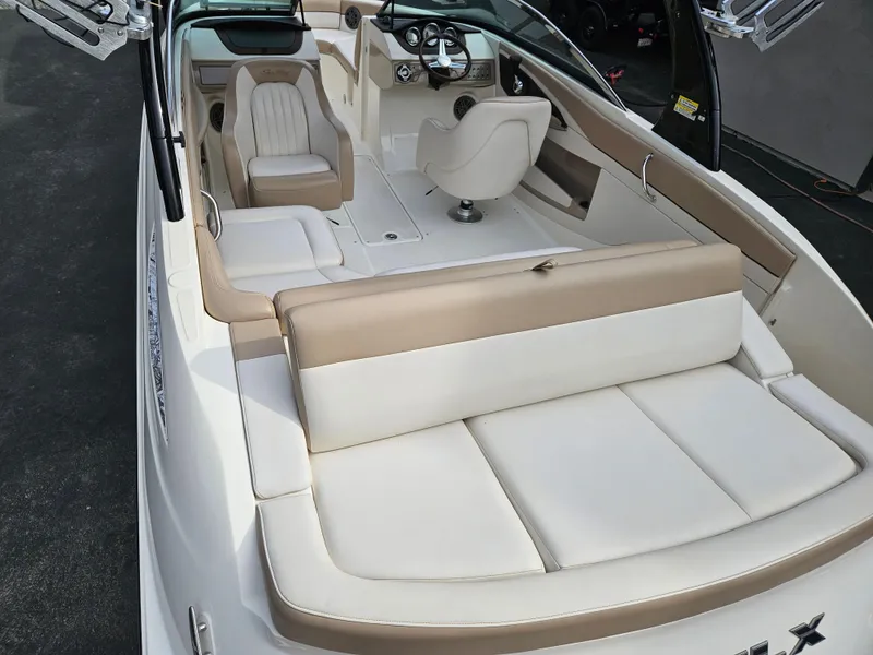 Slide: The Image of 2013 Sea Ray 230 SLX boat interior with beige and white seating. - 25