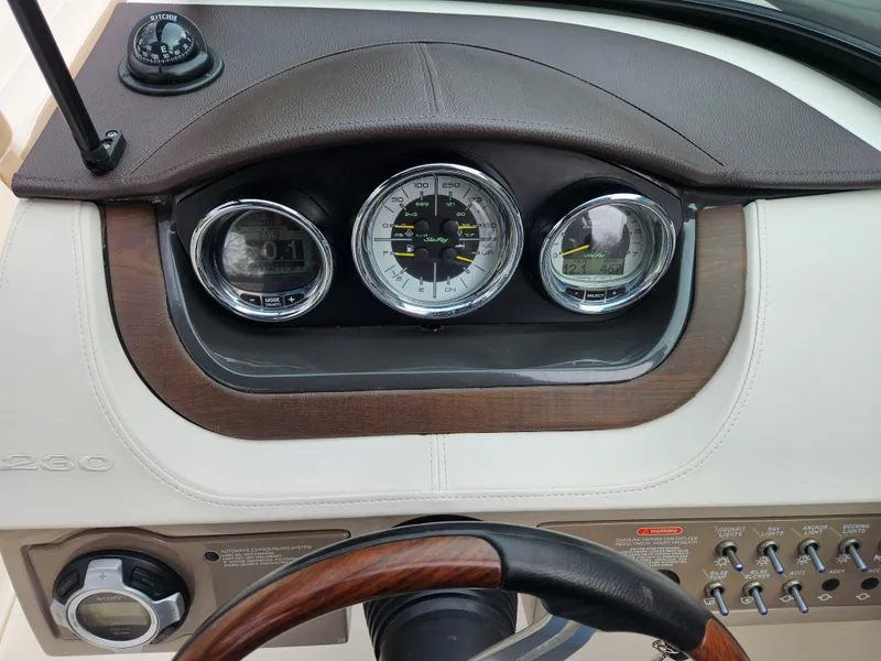 Slide: The Image of Dashboard of 2013 Sea Ray 230 SLX boat with gauges and controls. - 29