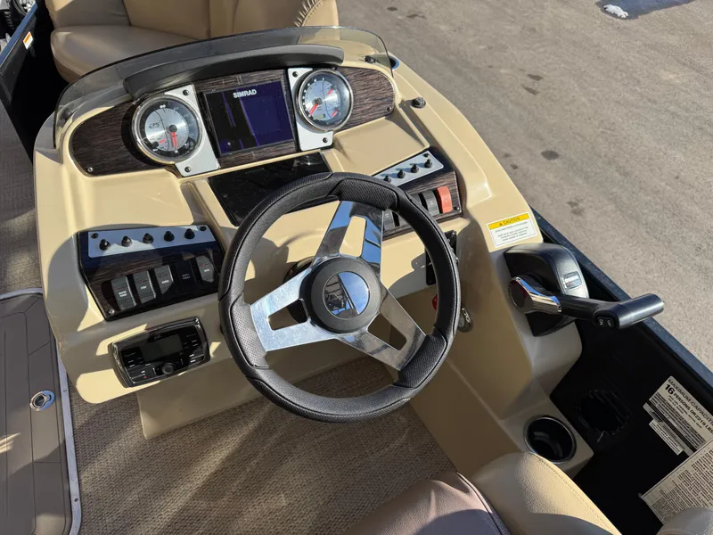 Slide: The Image of 2019 Godfrey Premium 235SD Sundeck helm with steering wheel and control panel. - 12