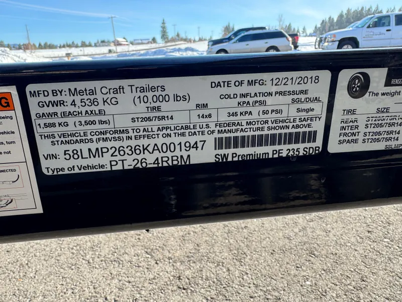 Slide: The Image of Label on Metal Craft Trailer, showing specifications and compliance details, manufactured in December 2018. - 18