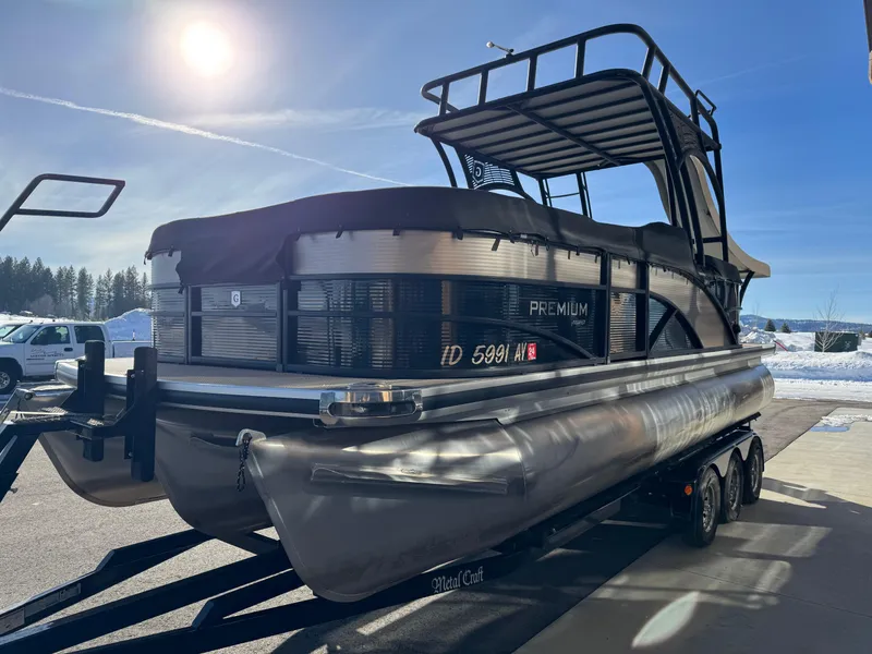 Slide: The Image of 2019 Godfrey Premium 235SD Sundeck pontoon boat on trailer under sunny sky. - 6