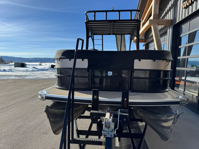 Slide: The Image of 2019 Godfrey Premium 235SD Sundeck boat on trailer, parked near snowy landscape. - 7