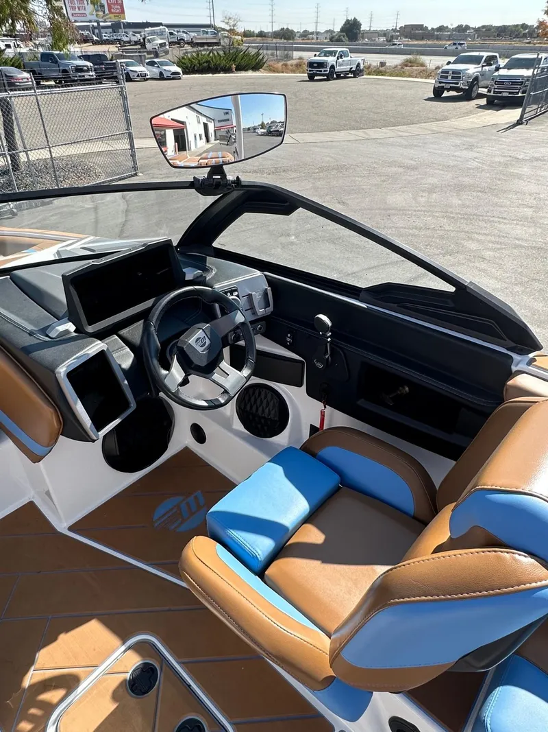 Slide: The Image of 2024 Malibu 22 LSV boat interior with modern dashboard and comfortable seating. - 15