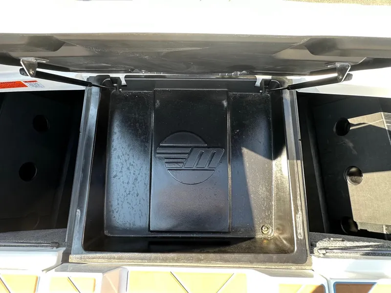 Slide: The Image of 2024 Malibu 22 LSV storage compartment with logo, open lid view. - 17