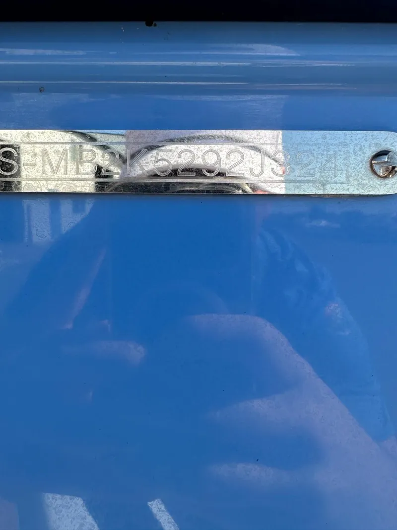 Slide: The Image of 2024 Malibu 22 LSV boat hull identification number on blue surface. - 21