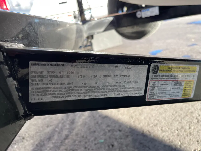 Slide: The Image of Close-up of a 2024 Malibu 22 LSV boat trailer label with specifications. - 13