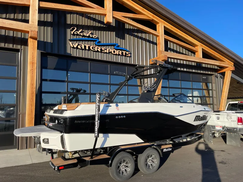 Slide: The Image of 2024 Malibu 22 LSV boat on trailer at Idaho Water Sports dealership. - 3