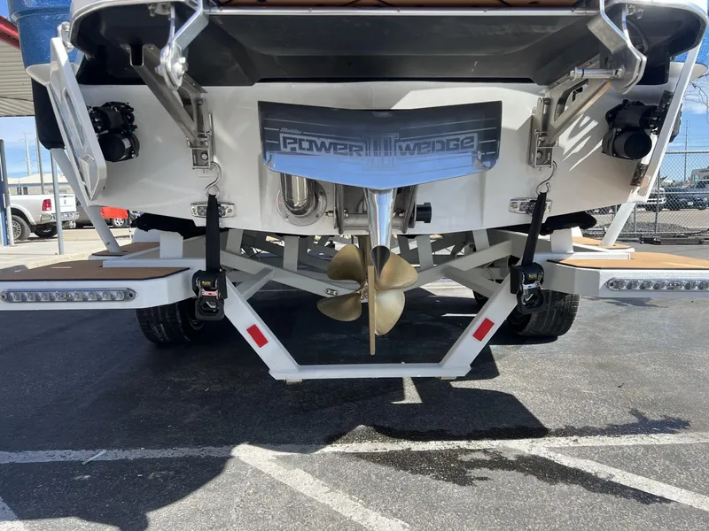 Slide: The Image of 2024 Malibu 23 LSV boat rear view with Power Wedge and propeller. - 10