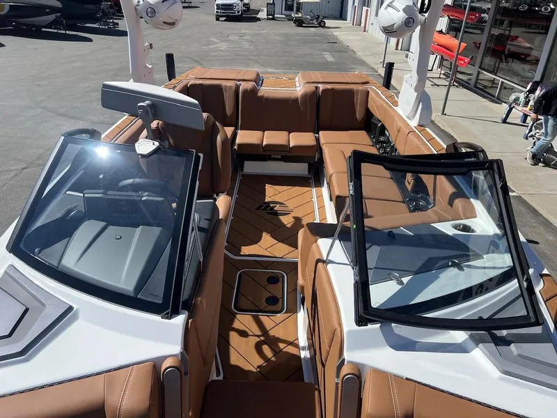 Slide: The Image of 2024 Malibu 23 LSV boat interior with brown seating and modern design. - 19