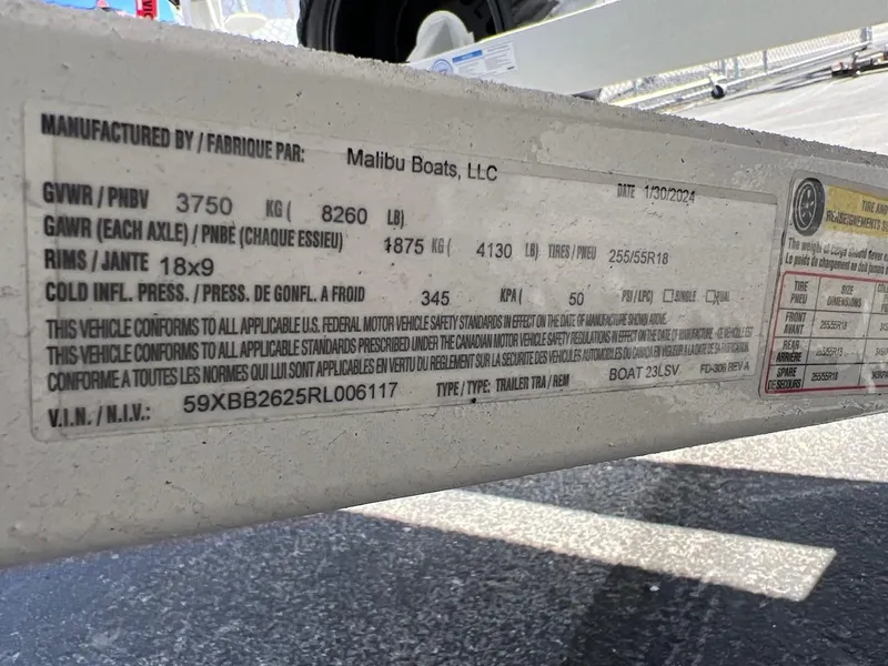 Slide: The Image of Label on 2024 Malibu 23 LSV boat trailer detailing specifications and compliance information. - 23
