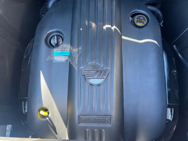 Slide: The Image of 2024 Malibu 24 MXZ Monsoon engine close-up, showcasing branding and components. - 21