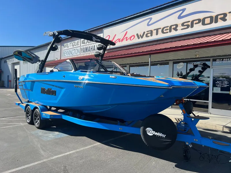 Slide: The Image of 2024 Malibu 24 MXZ boat in vibrant blue on trailer at Idaho Water Sports. - 3