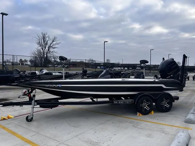 Slide: The Image of 2020 Skeeter ZX225 bass boat on trailer in parking lot. - 1