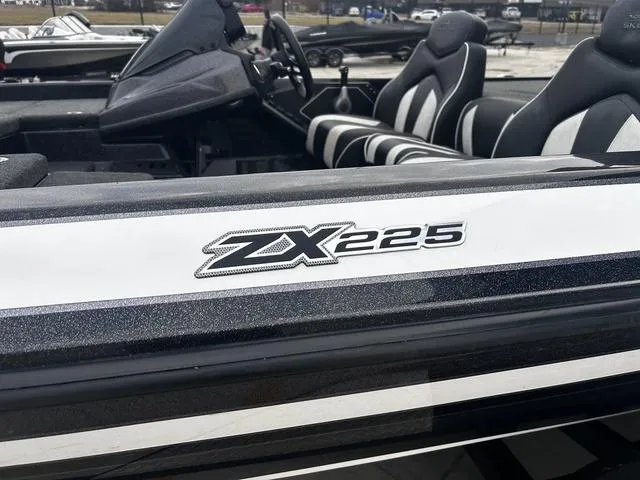 Slide: The Image of 2020 Skeeter ZX225 boat with sleek black and white design, featuring comfortable seating. - 2