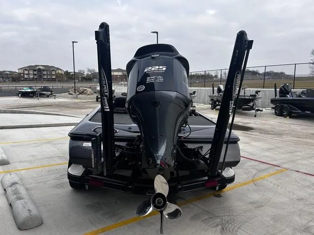 Slide: The Image of 2020 Skeeter ZX225 boat with powerful outboard motor, parked in a marina lot. - 4