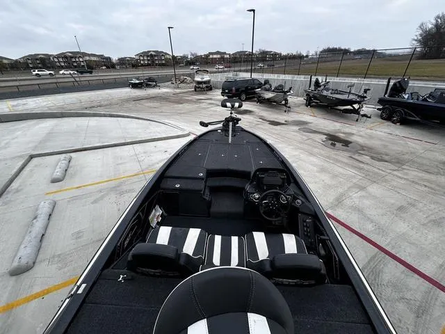 Slide: The Image of 2020 Skeeter ZX225 boat interior at a parking lot, showcasing seating and control panel. - 7