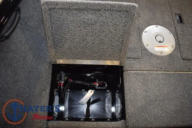 Slide: The Image of Battery compartment of 2025 Lund 1650 Rebel XL SS boat, open with visible wiring. - 14