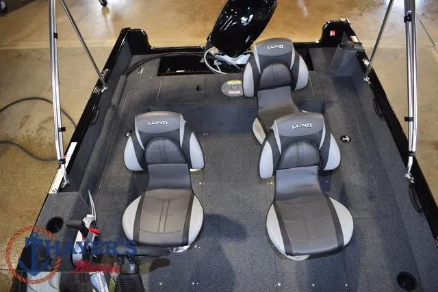 Slide: The Image of 2025 Lund 1650 Rebel XL SS boat interior with four gray seats. - 16