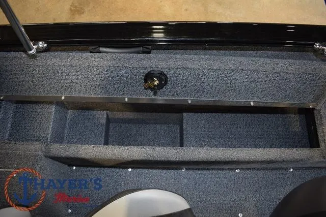 Slide: The Image of 2025 Lund 1650 Rebel XL SS boat interior storage compartment, gray carpeted finish. - 20