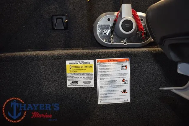 Slide: The Image of 2025 Lund 1650 Rebel XL SS boat capacity and safety labels, Thayer's Marine logo visible. - 24