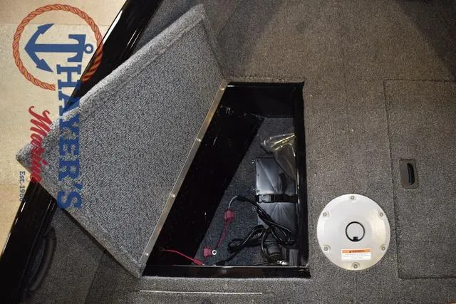 Slide: The Image of 2025 Lund 1650 Rebel XL SS boat storage compartment with open hatch and visible wiring. - 27