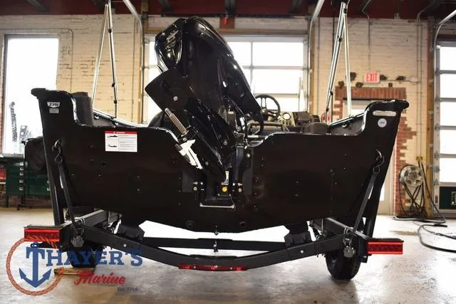 Slide: The Image of 2025 Lund 1650 Rebel XL SS boat on trailer in garage setting. - 4