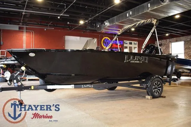 Slide: The Image of 2025 Lund 1650 Rebel XL SS boat displayed indoors at Thayer's Marine showroom. - 7