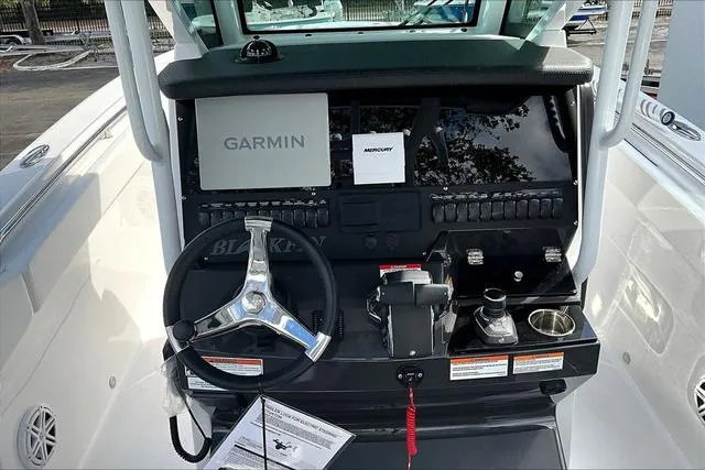 Slide: The Image of 2025 Blackfin 272CC boat dashboard with Garmin and Mercury displays. - 11