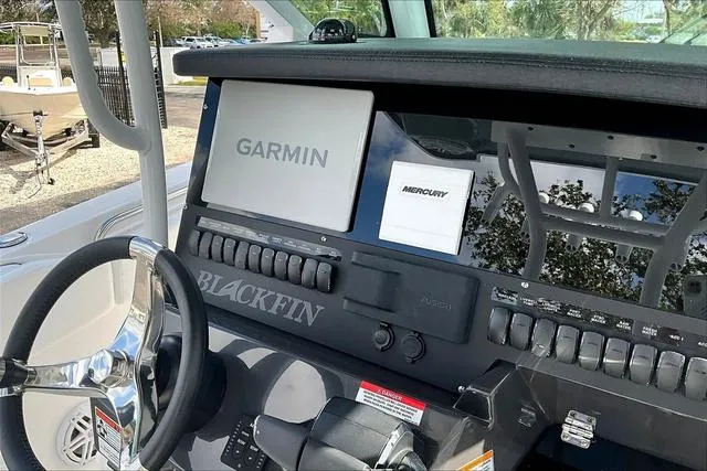 Slide: The Image of 2025 Blackfin 272CC boat dashboard with Garmin and Mercury displays. - 13