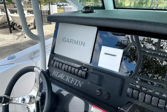 Slide: The Image of 2025 Blackfin 272CC boat dashboard with Garmin and Mercury displays. - 14