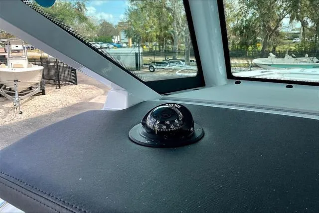 Slide: The Image of 2025 Blackfin 272CC boat interior with compass on dashboard, showcasing navigation features. - 15