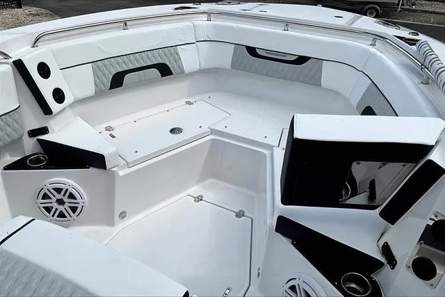 Slide: The Image of 2025 Blackfin 272CC boat interior with white seating and modern design. - 18