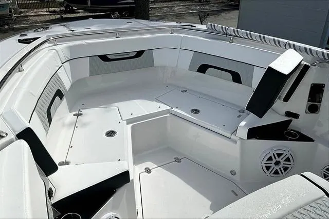 Slide: The Image of 2025 Blackfin 272CC boat interior with white seating and storage compartments. - 19