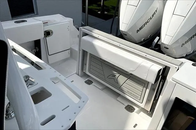 Slide: The Image of 2025 Blackfin 272CC boat interior with Mercury engines, featuring sleek seating and storage. - 20