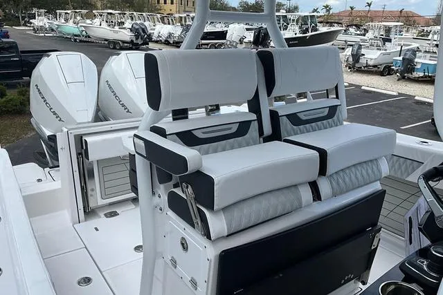 Slide: The Image of 2025 Blackfin 272CC boat with dual Mercury engines, featuring luxurious seating and modern design. - 34