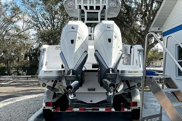 Slide: The Image of 2025 Blackfin 272CC boat with dual outboard engines, parked on a trailer. - 5