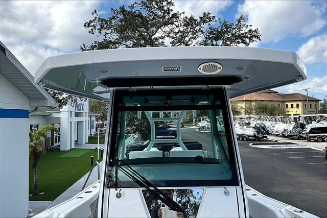 Slide: The Image of 2025 Blackfin 272CC boat at a marina, showcasing sleek design and modern features. - 9