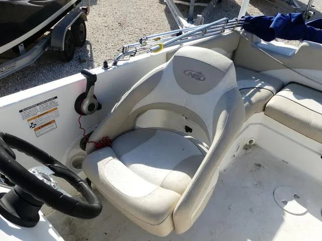 Slide: The Image of 2016 NauticStar 203 DC boat interior with steering wheel and seating area. - 11
