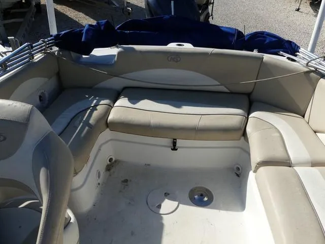 Slide: The Image of 2016 NauticStar 203 DC boat interior with beige seating and storage compartments. - 12