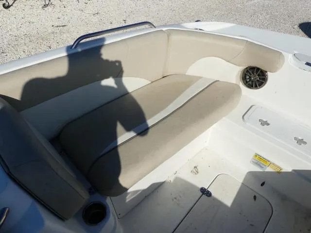 Slide: The Image of 2016 NauticStar 203 DC boat interior with beige seating and speaker. - 16