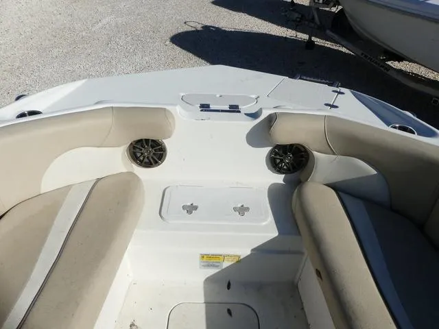 Slide: The Image of 2016 NauticStar 203 DC boat interior with beige seating and speakers. - 17