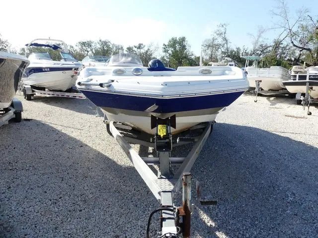 Slide: The Image of 2016 NauticStar 203 DC boat on trailer in a gravel lot. - 2