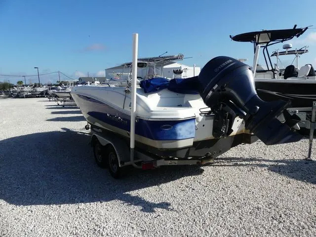 Slide: The Image of 2016 NauticStar 203 DC boat on trailer, parked on gravel lot. - 5